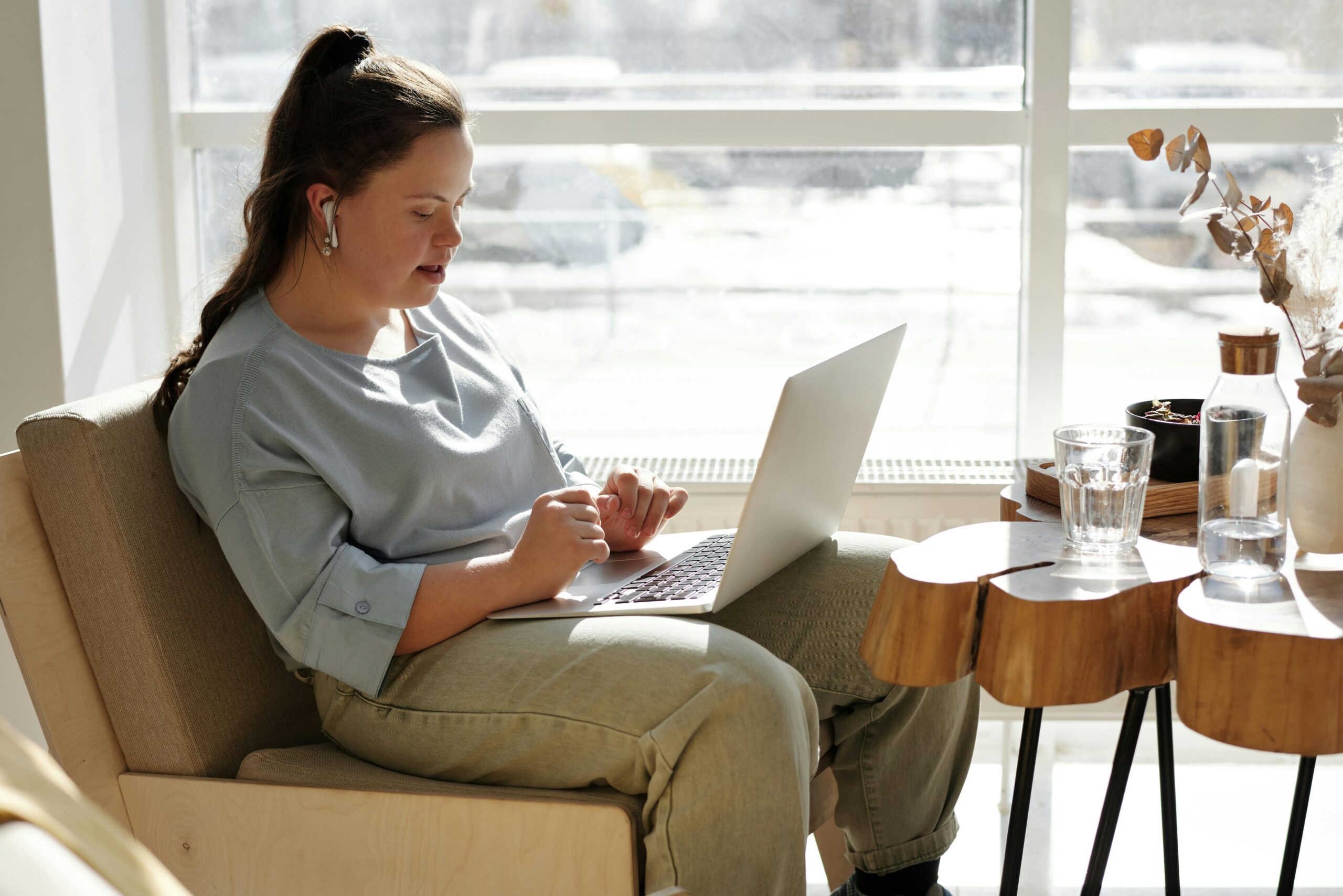 Young woman with a disability using a laptop at home
