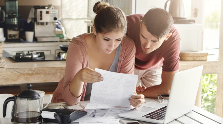A couple reviewing their financial statement at home